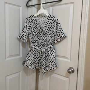 White and romper with black leopard heart with belt, loops, and additional belt.